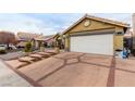 House exterior showcasing a white garage door and brick driveway at 6442 Cedar Breaks Ave, Las Vegas, NV 89156