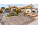 Front yard with fountain and brick paver driveway at 6442 Cedar Breaks Ave, Las Vegas, NV 89156