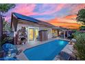 Backyard pool with solar panels and a patio, perfect for outdoor relaxation and entertaining at 725 Pacific Cascades Dr, Henderson, NV 89012