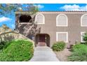 Exterior view of a light brown building with landscaping and walkway at 7950 W Flamingo Rd # 1041, Las Vegas, NV 89147