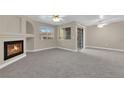 Living room with fireplace, carpet, and sliding glass door at 7950 W Flamingo Rd # 1041, Las Vegas, NV 89147