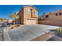 Inviting two-story home featuring a spacious driveway and attached two-car garage at 8736 Summoners Ct, Las Vegas, NV 89139