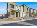 Two-story house with three-car garage and neutral color scheme at 10116 Rebel Coast St, Las Vegas, NV 89141