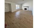 Bright living room features wood floors, a window, and a fireplace with painted brick surround at 1108 Smith St, Las Vegas, NV 89108