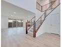 Bright and spacious entryway with modern staircase and wood flooring at 1225 Crimson Sunbird St, North Las Vegas, NV 89084