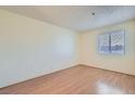 Bright bedroom with light wood flooring and a window with blinds at 1361 E University Ave # 209, Las Vegas, NV 89119