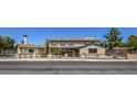Two-story home with a gated entrance, desert landscaping, and a classic car parked in the driveway at 1420 S 8Th St, Las Vegas, NV 89104