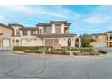 Two-story townhome with Mediterranean styling, landscaped grounds, and attached garage at 19 Via Visione # 204, Henderson, NV 89011