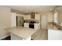Kitchen with granite counters, stainless steel appliances, and an island at 3390 Syvella Ct, Las Vegas, NV 89117
