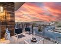 Balcony with chairs and table offers stunning sunset view at 4269 Solace St # 0, Las Vegas, NV 89135