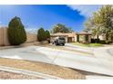 Spacious driveway leading to a home with mature trees and charming landscaping at 4401 Inez Dr, Las Vegas, NV 89130