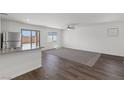 Spacious living room with dark laminate floors and a ceiling fan at 4922 Canna Lily St, Las Vegas, NV 89122