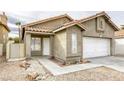 Front view of a house with a walkway and drought-tolerant landscaping at 5055 Jacarilla Ln, North Las Vegas, NV 89031