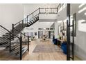 Bright and spacious entryway with modern staircase and hardwood floors at 5219 Iron River Ct, Las Vegas, NV 89135