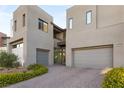 Modern home with two-car garage and manicured landscaping at 5219 Iron River Ct, Las Vegas, NV 89135