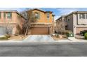 Two-story house with brown exterior, attached garage, and landscaping at 6966 Placid Lake Ave, Las Vegas, NV 89179