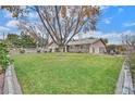 Large grassy front yard with mature trees at 7390 W Rome Blvd, Las Vegas, NV 89131