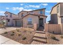 Charming two-story home with desert landscaping, brick walkway, and an attached two-car garage at 745 Black Palace St, Henderson, NV 89011