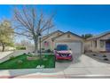 Front view of a single-story house with a red SUV parked in the driveway at 8925 Medicine Wheel Ave, Las Vegas, NV 89143