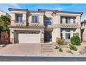 Two-story house with a three-car garage and landscaping at 9472 Ojibwa Ave, Las Vegas, NV 89149