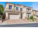 Two-story house with a three-car garage and landscaping at 9472 Ojibwa Ave, Las Vegas, NV 89149