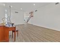 Large, bright open concept with wood floors and staircase at 9668 Padre Peak Ct, Las Vegas, NV 89178