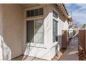 Side yard with a gated access and a large window at 10540 Beachwalk Pl, Las Vegas, NV 89144