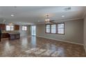 Spacious living area with tile floors, ceiling fan, and sliding doors to the backyard at 11106 Cherokee Landing St, Las Vegas, NV 89179