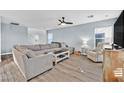 Spacious living room with L-shaped sectional sofa and hardwood floors at 11157 Sandrone Ave, Las Vegas, NV 89138