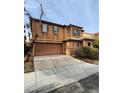 Two-story house with attached garage and driveway at 11185 Saddle Iron St, Las Vegas, NV 89179