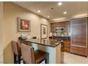 Modern kitchen with stainless steel appliances and breakfast bar at 125 E Harmon Ave # 1702, Las Vegas, NV 89109