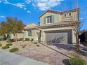 Tan two-story house with tile roof, shutters, and a gray garage door at 12846 Ringrose St, Las Vegas, NV 89141