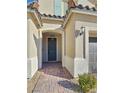 Front entrance with a dark gray door and brick walkway at 12846 Ringrose St, Las Vegas, NV 89141