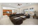 Open living room with a large sectional sofa and view of the kitchen at 2 Lago Turchino Ct, Henderson, NV 89011