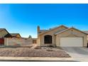 Inviting single-Gathering home featuring a desert landscape and a spacious two-car garage at 2177 Bridle Wreath Ln, Las Vegas, NV 89156