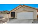 View of an attached two-car garage and an arched window on a single Gathering home at 2177 Bridle Wreath Ln, Las Vegas, NV 89156