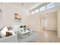 Bright living room featuring a white sofa, marble coffee table, and clerestory windows at 2520 Palmridge Dr, Las Vegas, NV 89134