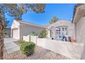 Front view of the house with a patio and seating area at 2612 Harrisburg Ave, Henderson, NV 89052