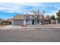 Two-story house with attached garage and mature tree in front at 2923 Palora Ave, Las Vegas, NV 89121