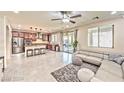 Open living room with light taupe sectional sofa and access to kitchen at 2934 Tremont Ave, Henderson, NV 89052