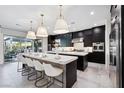 Modern kitchen with island, stainless steel appliances, and white quartz countertops at 304 Elder View Dr, Las Vegas, NV 89138