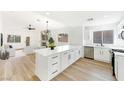 Modern white kitchen with stainless steel appliances and island at 3327 Erva St # 205, Las Vegas, NV 89117