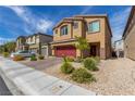 Two-story house with red garage door, landscaping, and driveway at 4036 Floating Fern Ave, North Las Vegas, NV 89084