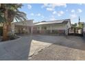 Single-story home with solar panels, gated entrance and large driveway at 4365 Topaz St, Las Vegas, NV 89121