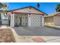 Attractive single-story home featuring a two-car garage with a black and white door design at 4721 Via Renaldo, Las Vegas, NV 89103