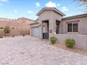 Modern home with a paved driveway and drought-tolerant landscaping at 49 Strada Caruso, Henderson, NV 89011