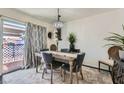 Elegant dining room with a wood table and gray velvet chairs at 526 Sellers Pl, Henderson, NV 89011