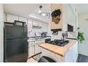 White kitchen features butcher block countertops and stainless steel appliances at 526 Sellers Pl, Henderson, NV 89011