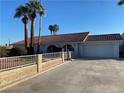 Front view of a white single-story home with a garage and fence at 5515 Coley Ave, Las Vegas, NV 89146