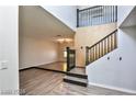 Living room with a raised platform and hardwood flooring at 722 Barrie Ct, Henderson, NV 89002